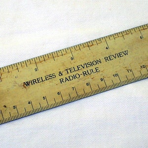 Vintage radio rule, advertising Wireless & Television Review. 1930s. Metal metres to kilocyles converter and ruler. Radio TV engineer&#39;s tool