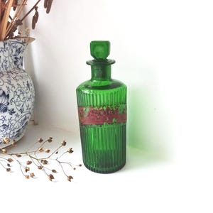 Antique green pharmacy bottle with original stopper and remains of old red label, Wood Brothers ribbed bottle, Edwardian apothecary bottle