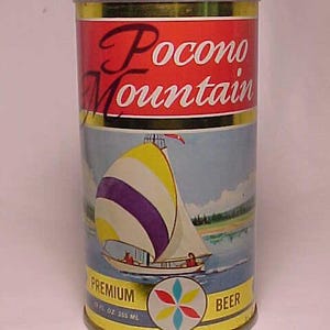 May include: A yellow and red aluminum can of Pocono Mountain Premium Beer. The can features a sailboat with a purple and yellow sail on a blue lake with green trees in the background. The can is 12 fl oz (355 ml).