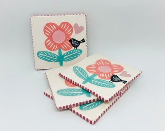 Set of 4 Handmade Ceramic Coasters each Hand Painted with a Flower and a Little Black Bird