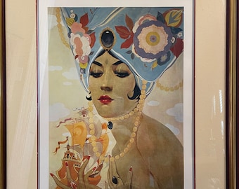 May include: A framed print of a woman wearing a blue and floral turban, holding a small ship in her hand. The woman is wearing a pearl necklace and a ring with a large blue gemstone. The print is titled "Scheherazade" by "Alredo Vargas" and is numbered 50/100.