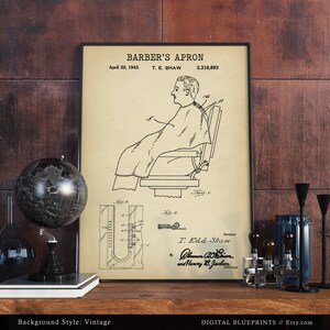 May include: A vintage patent drawing for a barber's apron. The drawing shows a person sitting in a barber's chair wearing the apron. The patent number is 2,316,893 and the date is April 20, 1943.
