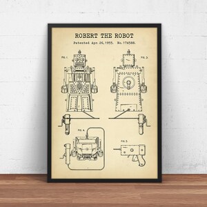 May include: A vintage patent drawing for a robot toy called "Robert the Robot". The drawing shows different views of the robot, including its front, back, and side. The patent was filed on April 26, 1955, and the patent number is 174588.