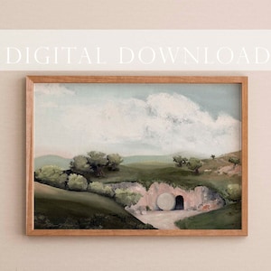 May include: A digital painting of a landscape with a large stone tomb, a rolling green hill, and a cloudy sky. The tomb has a large, round stone door that is open. The painting is framed in a light brown wood frame.