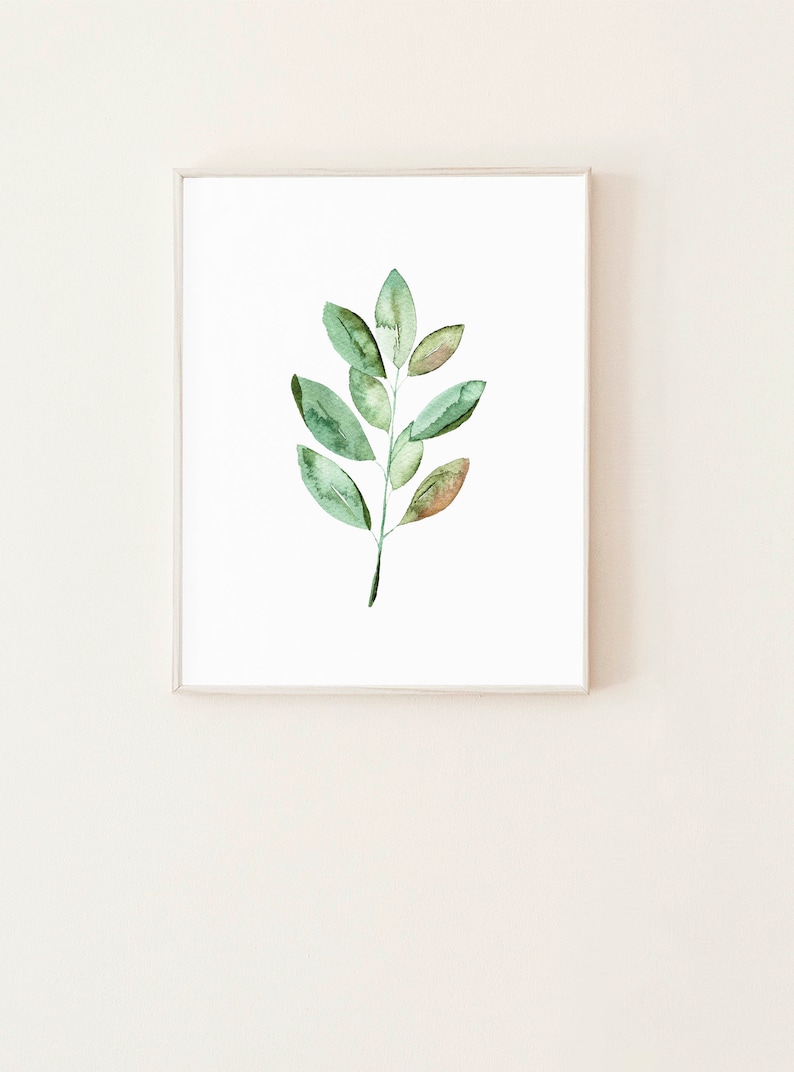 May include: A framed watercolor painting of a green leaf branch with a white background.