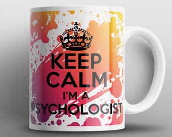 May include: White ceramic mug with a colorful splatter design. The mug features the text "Keep Calm I'm a Psychologist" with a crown above the text.