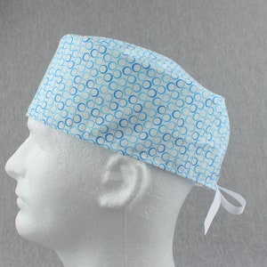 Blue circles pattern tieback scrub hat, surgical hat, chefs hat, head cover cap with options for Terry Cloth Sweatband and/or Buttons