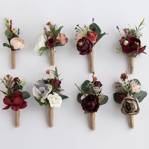 May include: Eight burgundy, blush, and white floral buttonholes with greenery and hessian twine.