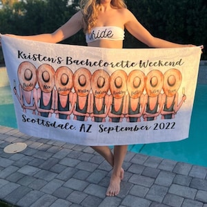 May include: White beach towel with a personalized design featuring a group of women in black swimsuits and straw hats. The text on the towel reads "Kristen's Bachelorette Weekend, Scottsdale, AZ September 2022".