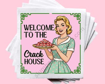 May include: A stack of white paper napkins with a pink square featuring a retro illustration. The illustration shows a woman in a green dress holding a tray of red objects, with the text "WELCOME TO THE CRACK HOUSE" in black.