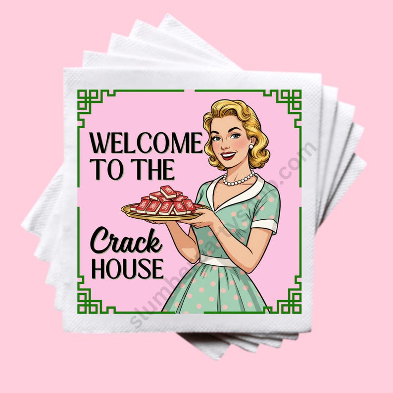 May include: A stack of white paper napkins with a pink square featuring a retro illustration. The illustration shows a woman in a green dress holding a tray of red objects, with the text "WELCOME TO THE CRACK HOUSE" in black.