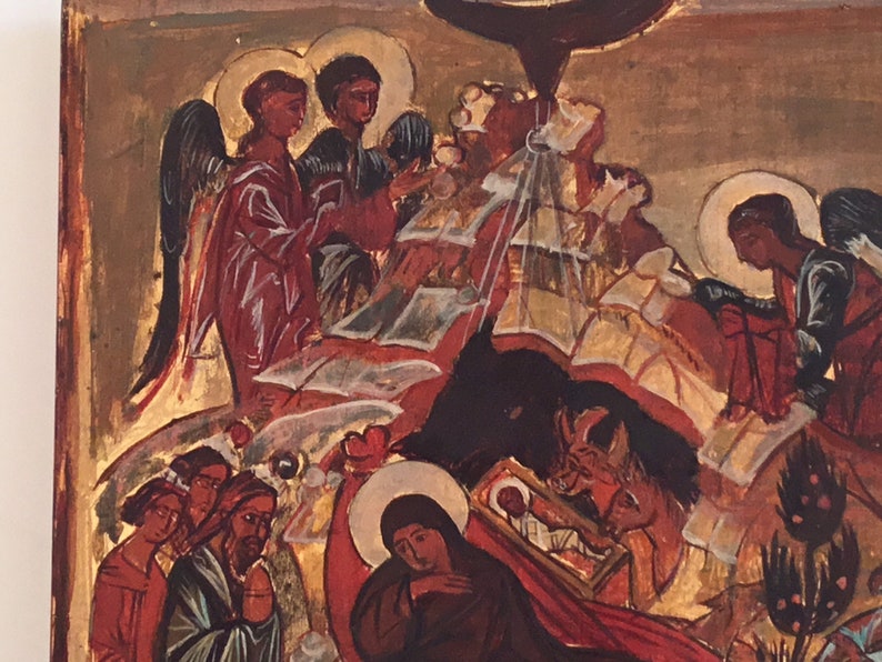 May include: An antique religious icon painting depicting a biblical scene. The artwork features figures in red, gold, and brown hues, with angels and halos. The style suggests a historical or Byzantine influence, with detailed brushwork.