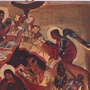 May include: An antique religious icon depicting a biblical scene. The artwork features figures with halos, angels, and a central figure in a manger. The color palette includes gold, red, and brown tones, with visible brushstrokes.