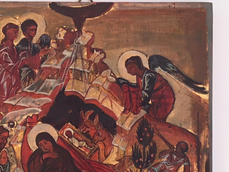 May include: An antique religious icon depicting a biblical scene. The artwork features figures with halos, angels, and a central figure in a manger. The color palette includes gold, red, and brown tones, with visible brushstrokes.