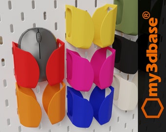 May include: A pegboard with a variety of mouse holders in different colors, including red, orange, yellow, pink, blue, green, black, and white. The mouse holders are designed to hold a computer mouse securely. The pegboard has a white background and is made of plastic. The text "my3dbase®" is visible in the upper right corner of the image.