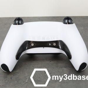 May include: White video game controller with black accents and buttons. The controller has a textured surface and is designed for use with a gaming console. The controller is made by my3dbase.