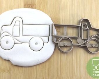 May include: A metal cookie cutter in the shape of a vintage dump truck. The cutter is food grade and has a detailed design.