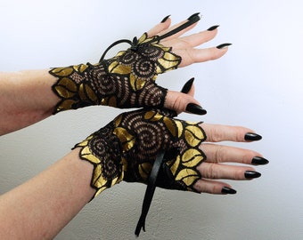 auffällige Pulswärmer | Handschuhe fingerlos in schwarz gold glänzend mit riesigen Blumen + Schleife