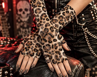May include: Fingerless gloves made of a tan and black leopard print mesh fabric. The gloves extend from the knuckles to the mid-forearm, featuring a scalloped edge at the fingers and a sheer, lightweight construction with a repeating animal pattern.