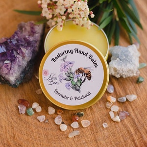 Ninas Bees Restoring Hand Balm is a honey colour, highly fragrant beeswax balm in a golden aluminium tin.  "Indulge in the beauty of eco-friendly skincare. Nina’s Bees Restoring Hand Balm: the perfect blend of nature and luxury