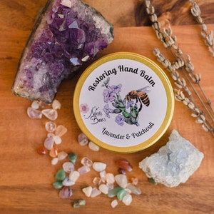 Nina's Bees Restoring Hand balm is created with organic oils and butters and beeswax from our apiary. Restoring hand balm is formulated for dry skin. the balm comes in a golden aluminium tin with a paper label. Environmentally friendly packaging