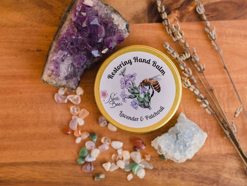 Nina's Bees Restoring Hand balm is created with organic oils and butters and beeswax from our apiary. Restoring hand balm is formulated for dry skin. the balm comes in a golden aluminium tin with a paper label. Environmentally friendly packaging