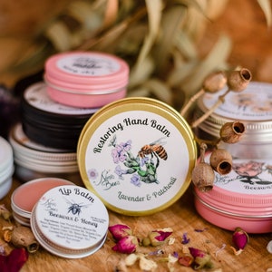 Ninas Bees Lip balm is next to other ninas bees balms. all balms are in colourful aluminium tins. It is a sustainable and environmentally friendly packaging for balms. Ninas bees balms have recycled paper labels