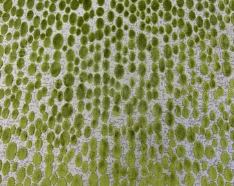 May include: Close-up of a fabric with a pattern of green, oval-shaped tufts on a light gray background. The tufts are densely packed and create a textured surface, suitable for upholstery or decorative purposes.