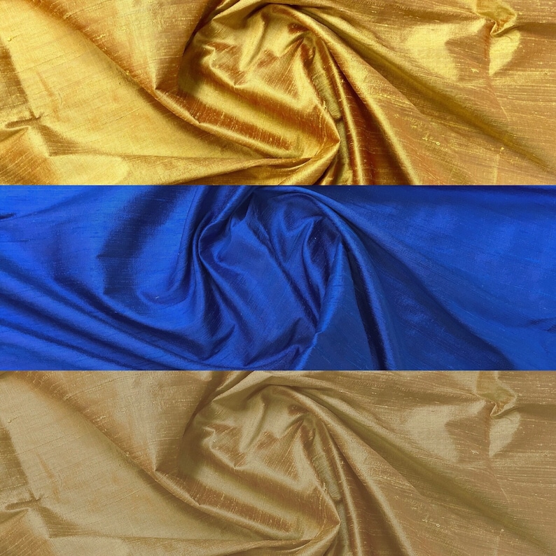 Puede incluir: Tres muestras de tela en diferentes colores: dorado, azul y dorado m&aacute;s claro. La tela es suave y sedosa.