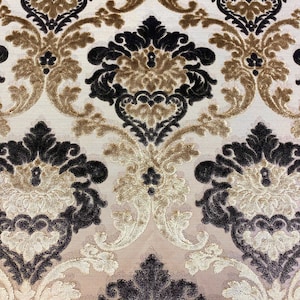 May include: A close-up of a fabric with a damask pattern in black, brown, and cream colors.