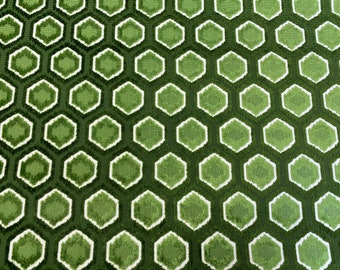 May include: A fabric featuring a repeating geometric pattern of interlocking hexagons in various shades of green, including dark forest green, olive, and lime, with white outlines surrounding each individual hexagonal shape.