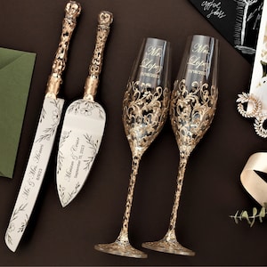 May include: A wedding cake cutting set featuring a knife and server, both with gold handles and floral designs. The set is personalised with the names "Mr. & Mrs. Lopez" and the date "September 10, 2023". Two champagne flutes with gold floral designs and the same names and date are also included.