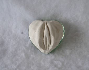 Sculpted Vulva on a greenish Clear Glass Paperweight 184