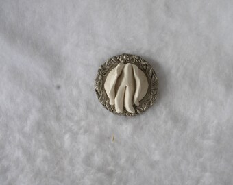 Sculpted Vulva in a Round Metal Dish With Incised Floral Edge Decoration 187