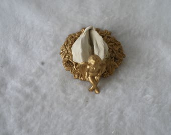 Sculpted Vulva in a Composite Incised Floral Frame Painted Gold With Seated Putto 195