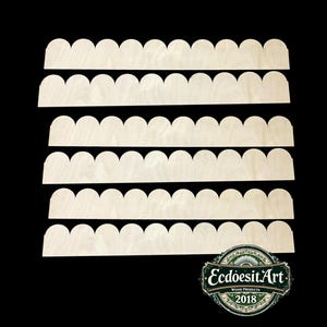 May include: Several unfinished wooden scalloped edge pieces arranged on a black background. The wood has a light, natural color. A green and white logo in the bottom right corner reads "EcdoesitArt WOOD PRODUCTS 2018."