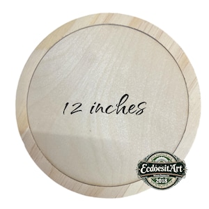 May include: A round, unfinished wooden plaque with a light wood grain. The text "12 inches" is written in black script across the center. A decorative logo for "EcdoesitArt Wood Products 2018" is in the lower right corner.