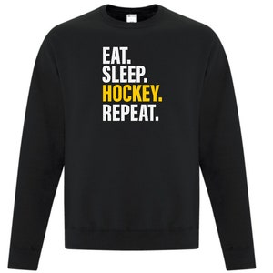 May include: Black sweatshirt with the text "EAT. SLEEP. HOCKEY. REPEAT." in white and yellow.