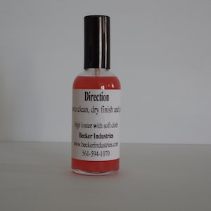 May include: A clear bottle with a red liquid and a white label that says "Direction" and includes instructions for use. The label also includes the company name "Becker Industries" and their website and phone number.