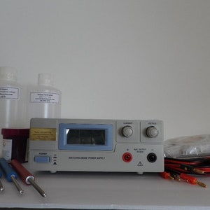 May include: A silver electroplating kit with a power supply, two bottles of solution, a jar of plating solution, three metal probes, and two red and black wires.
