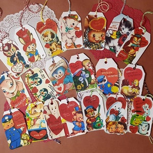 May include: A collection of vintage Valentine's Day gift tags featuring various illustrations and messages. The tags are printed on white cardstock with red hearts and are tied with red and white string. Some of the messages include "You are my Valentine", "Be my Tweet Heart", "Stolen Valentine", and "Eager for you".