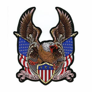 May include: Embroidered patch featuring a detailed bald eagle with outstretched wings, set against a backdrop of the American flag. The design includes the text "IN GOD WE TRUST" on a banner, with a shield bearing stars.
