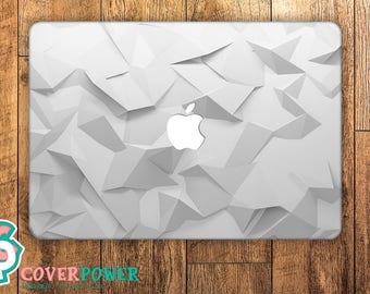 May include: White laptop skin with a geometric pattern and the Apple logo in the center.