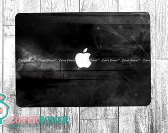 May include: Black laptop skin with a white Apple logo and a subtle white design resembling a spider web.