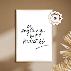 May include: A framed art print with the handwritten phrase "be anything but predictable" in black script on a white background. The print is in a light wood frame and includes a digital download icon.