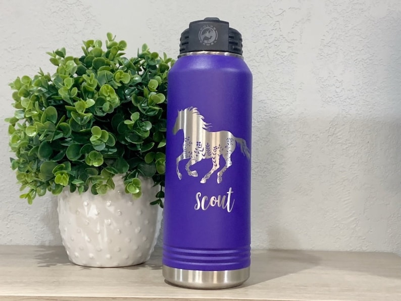 May include: Purple stainless steel water bottle with a silver horse design and the word "Scout" engraved on the side.