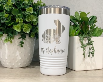 May include: White stainless steel tumbler with a floral bunny design and the name "Ms. Stephanie" engraved on the front.