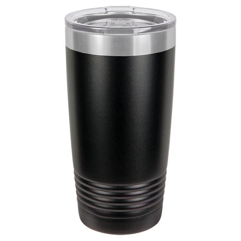 May include: A black insulated tumbler with a clear lid and a silver rim. The tumbler has a cylindrical shape with a textured, matte finish. The bottom of the tumbler features a series of horizontal ridges.
