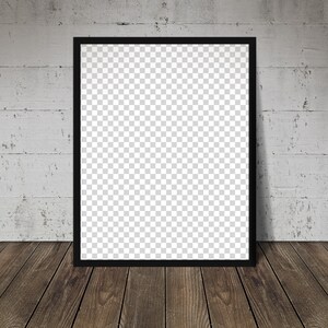 May include: A black picture frame with a blank white canvas inside. The frame is hanging on a white brick wall above a wooden floor.