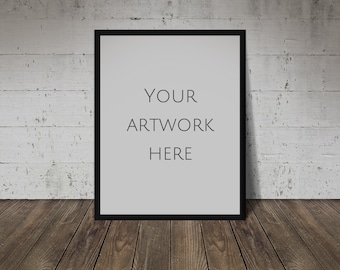 Könnte beinhalten: Ein schwarzer Bilderrahmen mit einem weißen Passepartout und dem Text "YOUR ARTWORK HERE" vor einem weißen Ziegelmauer Hintergrund.